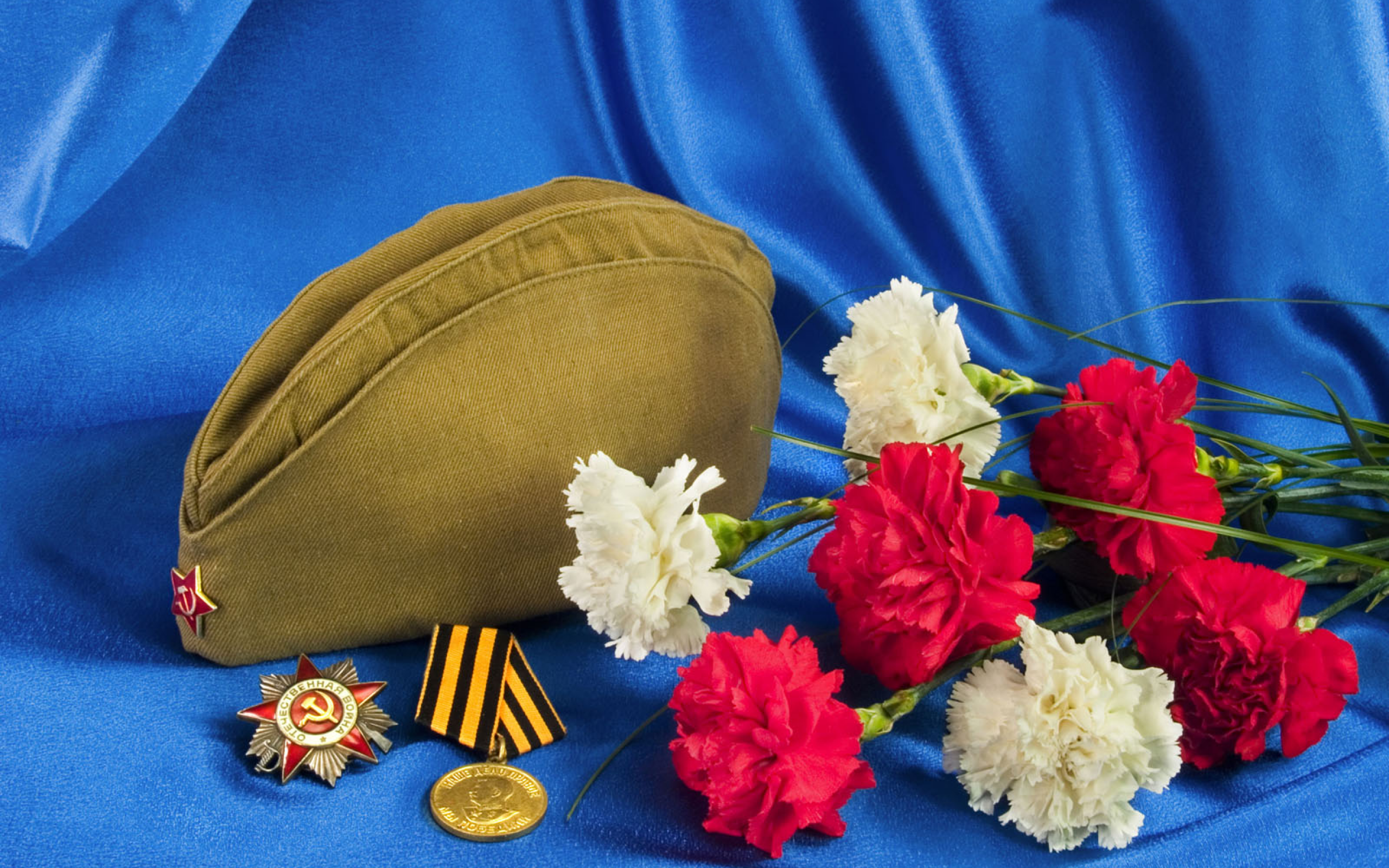 2019holidays may 9 bouquet of carnations field cap order of the patriotic war and a medal on a blue background 132073
