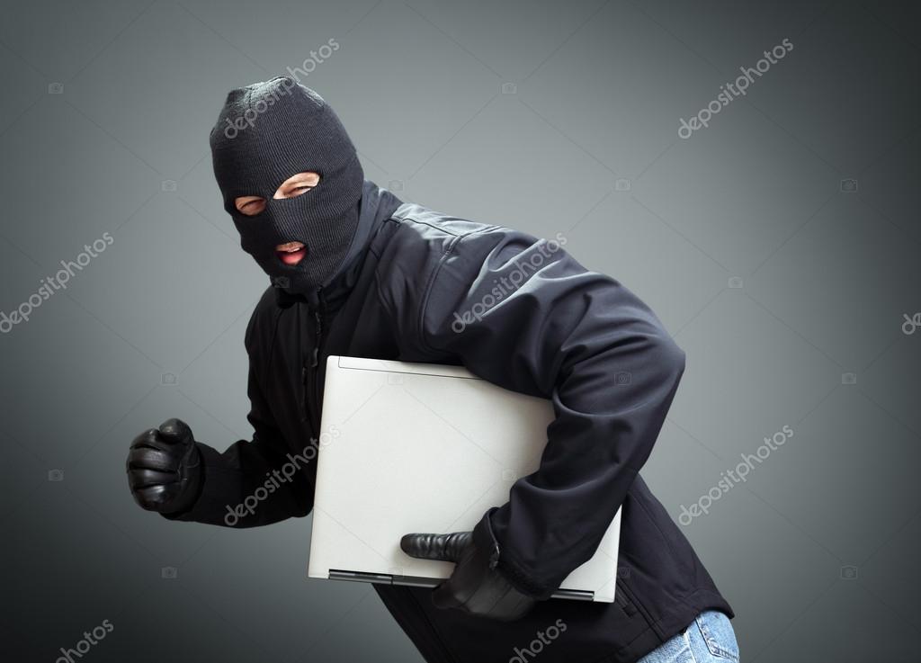 depositphotos 57913039 stock photo thief stealing laptop computer